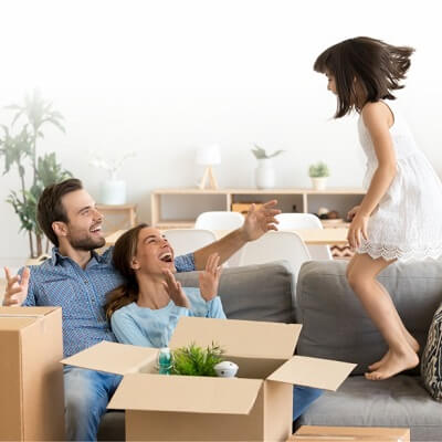Family smiling in living room with crates