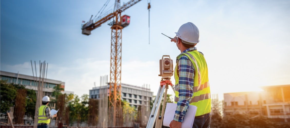A man at a construction and crane site