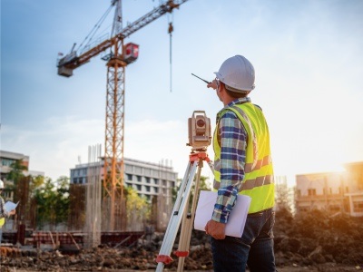A man at a construction and crane site
